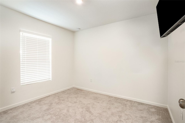 empty room featuring light carpet