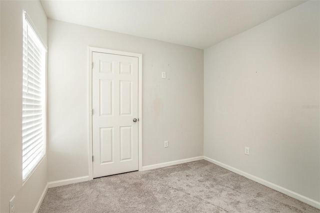 spare room with light colored carpet