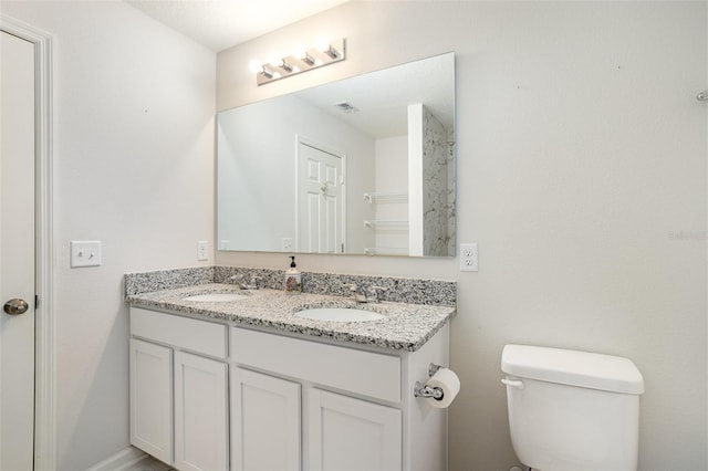 bathroom with toilet and vanity