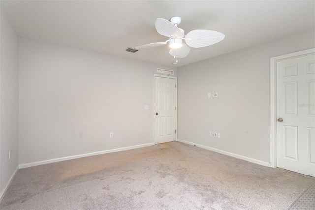 carpeted spare room with ceiling fan