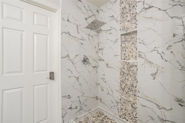 bathroom with tiled shower