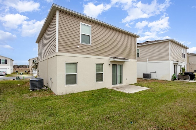 back of house featuring a lawn and central AC unit