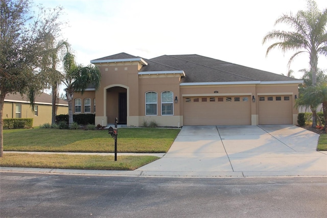 view of front of property featuring a front lawn and a garage