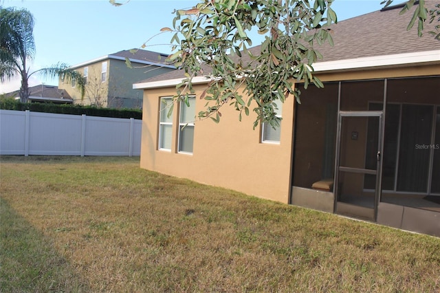 view of yard featuring a sunroom