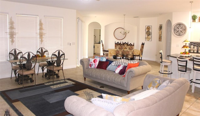 living room featuring a chandelier and light tile patterned floors