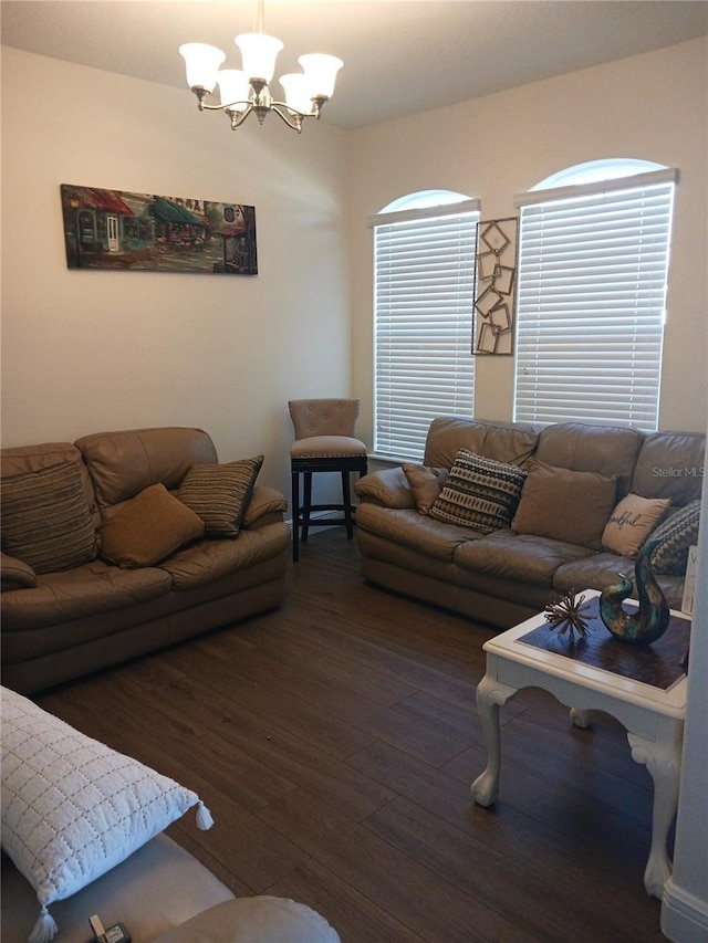 living room featuring dark wood-type flooring and a chandelier