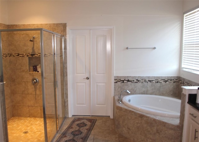 bathroom featuring tile patterned floors, separate shower and tub, and vanity