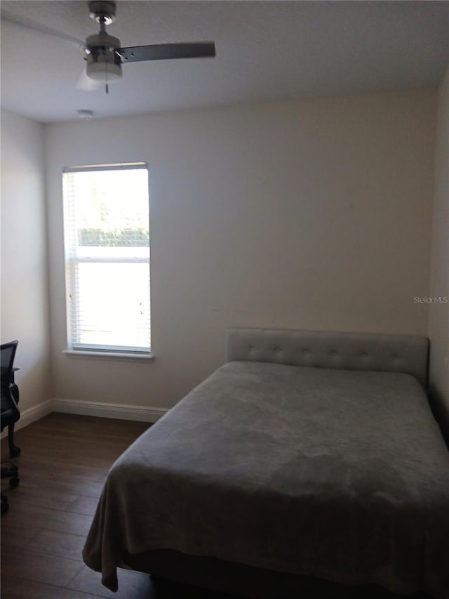 bedroom featuring dark hardwood / wood-style flooring and ceiling fan