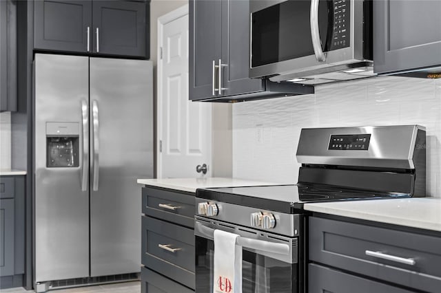 kitchen featuring gray cabinetry and appliances with stainless steel finishes