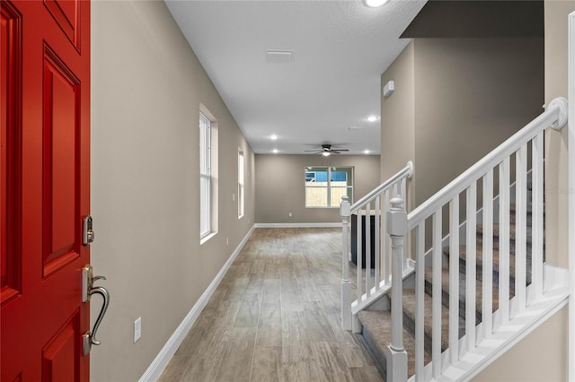 foyer with hardwood / wood-style floors and ceiling fan