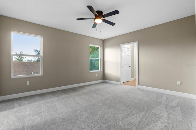 carpeted empty room featuring ceiling fan