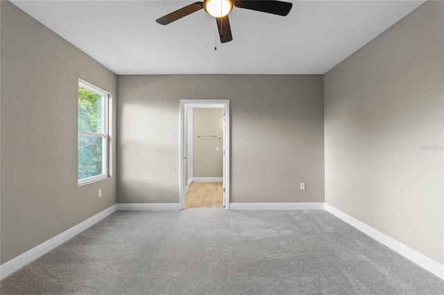 unfurnished room with light carpet and ceiling fan