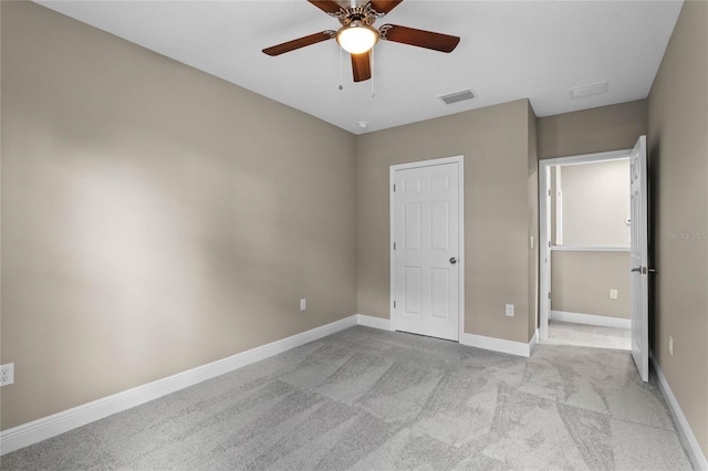 unfurnished bedroom with light colored carpet and ceiling fan