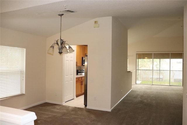 interior space with light carpet, lofted ceiling, and a notable chandelier