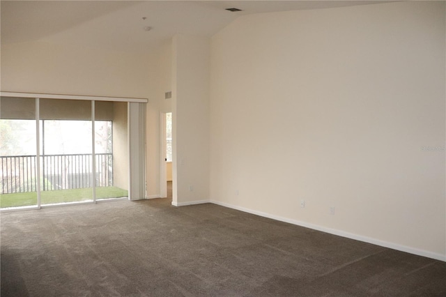 carpeted empty room featuring vaulted ceiling