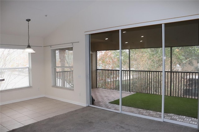 doorway with carpet floors and vaulted ceiling