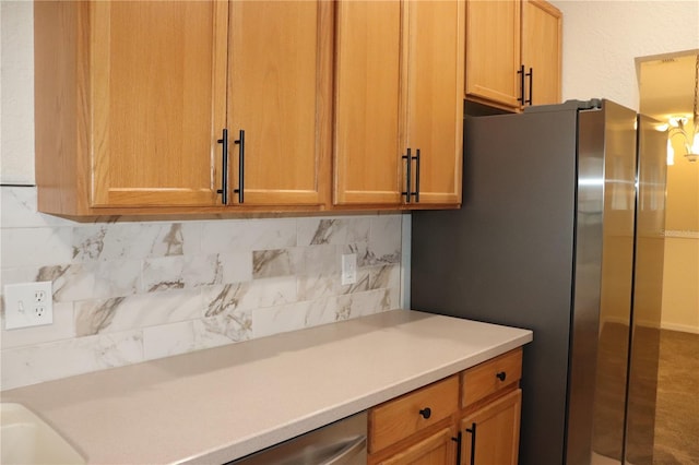 kitchen with backsplash and stainless steel refrigerator