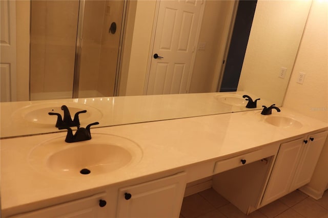 bathroom with tile patterned flooring, vanity, and a shower with shower door