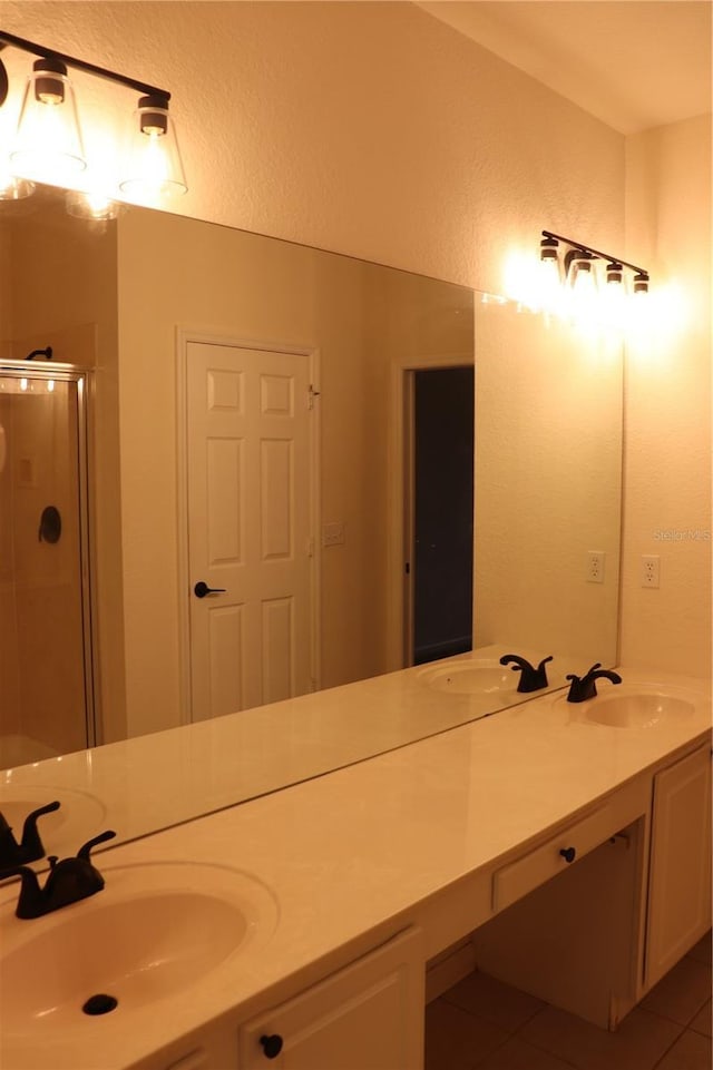 bathroom with tile patterned flooring, vanity, and an enclosed shower