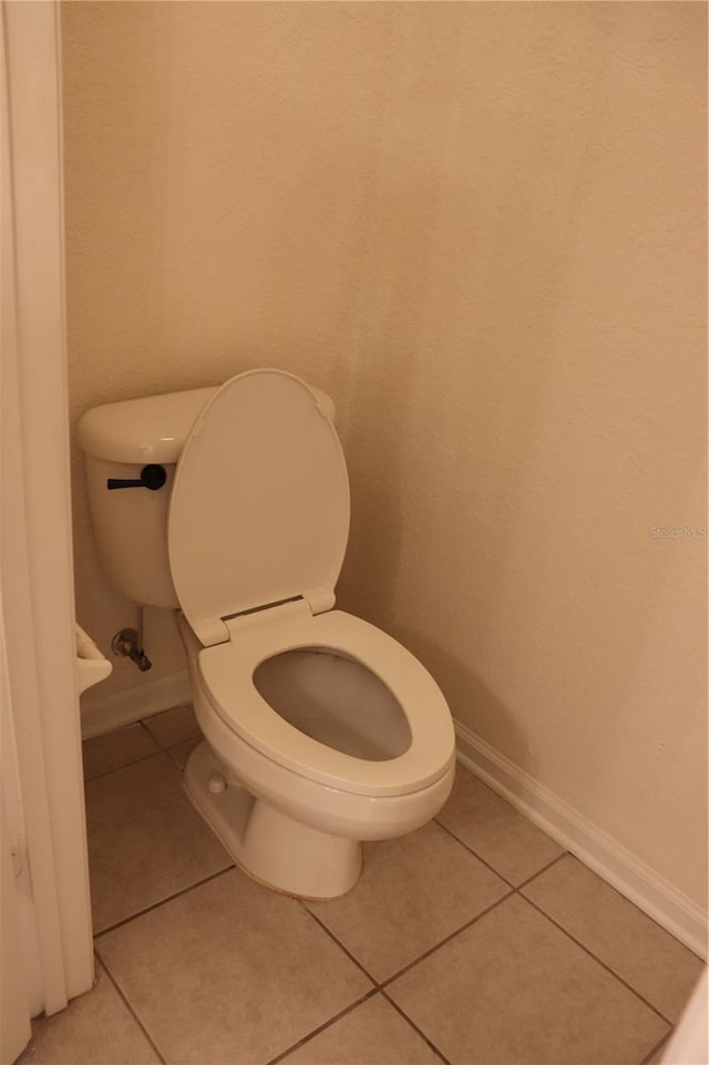 bathroom with tile patterned floors and toilet