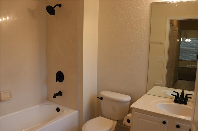 full bathroom with toilet, vanity, an inviting chandelier, and washtub / shower combination