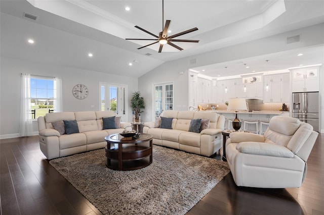 living room featuring dark hardwood / wood-style floors, ceiling fan, and lofted ceiling