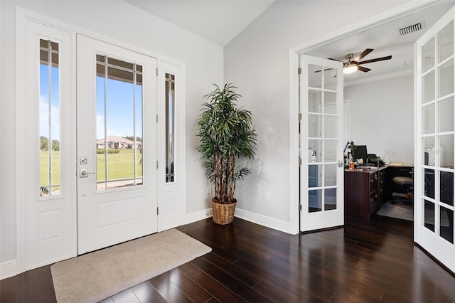 entrance foyer with ceiling fan, french doors, dark wood-type flooring, vaulted ceiling, and ornamental molding