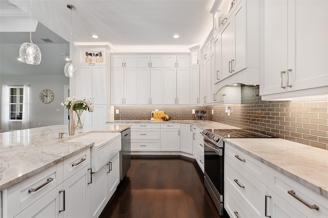 kitchen featuring sink, stainless steel appliances, dark wood-type flooring, decorative light fixtures, and white cabinets