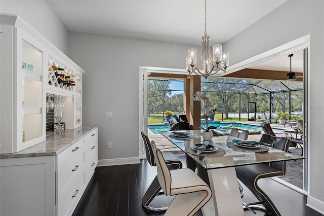 dining space featuring ceiling fan with notable chandelier and dark hardwood / wood-style flooring