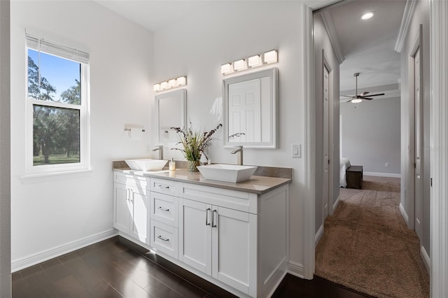 bathroom featuring vanity, ceiling fan, and wood-type flooring