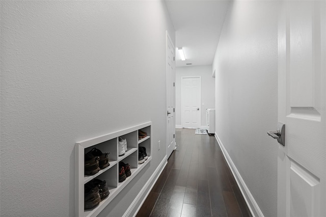 hallway with dark hardwood / wood-style floors