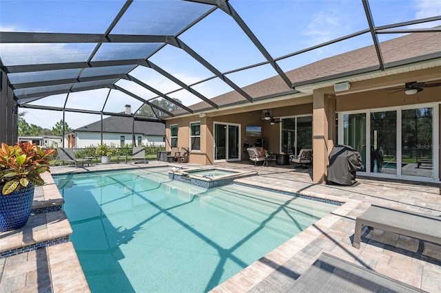 view of pool with a lanai, a patio area, ceiling fan, and an in ground hot tub