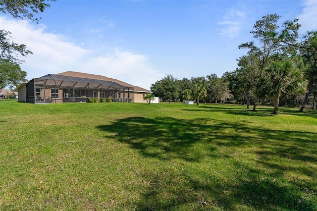 view of yard with glass enclosure