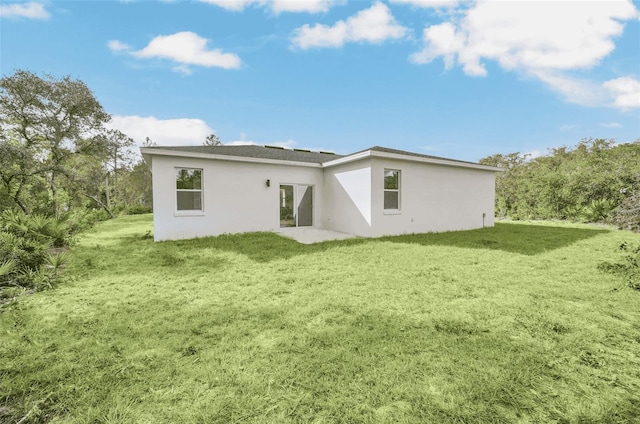 rear view of house with a yard