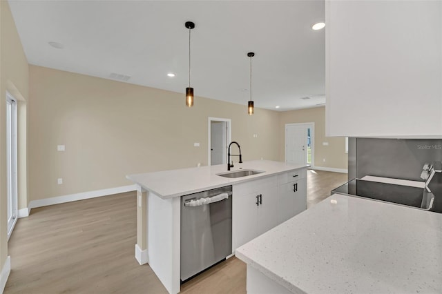 kitchen with pendant lighting, sink, dishwasher, white cabinetry, and an island with sink