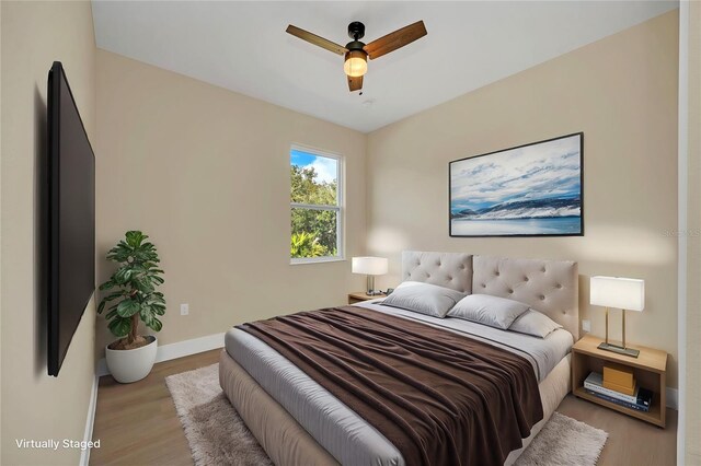 bedroom with ceiling fan and light hardwood / wood-style flooring