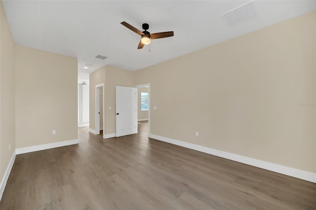 empty room with hardwood / wood-style floors and ceiling fan