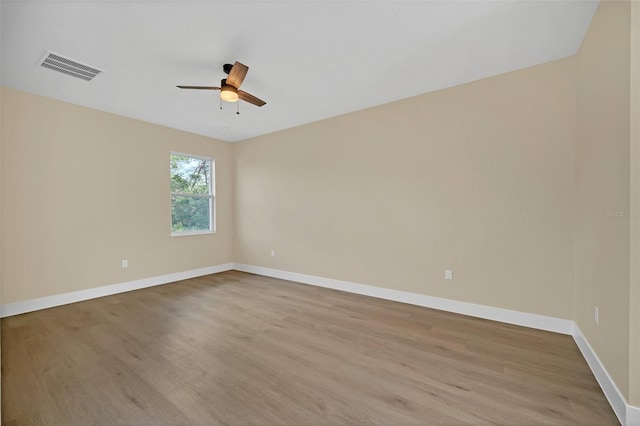 spare room with ceiling fan and light wood-type flooring