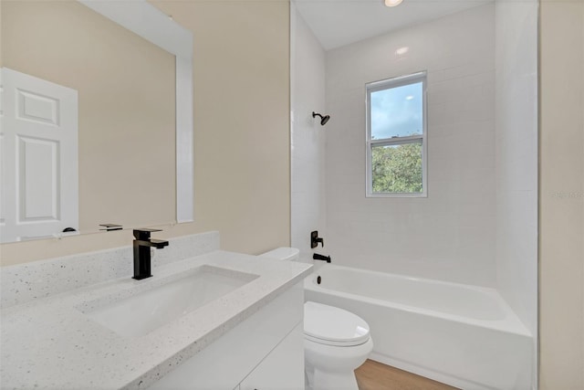 full bathroom featuring washtub / shower combination, vanity, toilet, and hardwood / wood-style floors