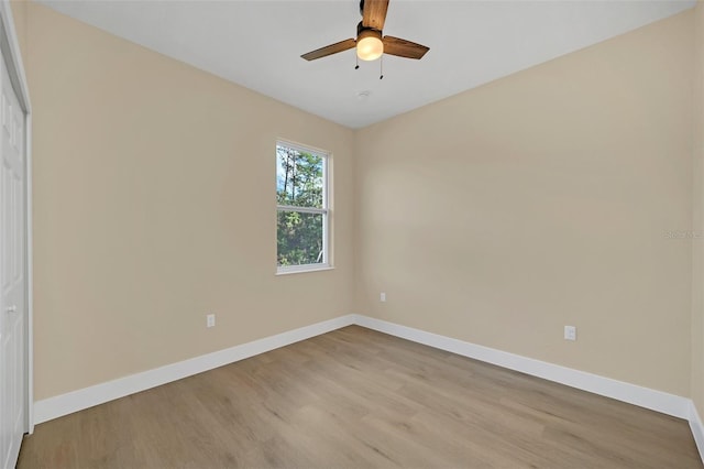 empty room with light hardwood / wood-style floors and ceiling fan