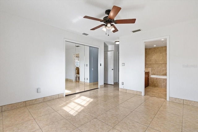 unfurnished room featuring light tile patterned floors and ceiling fan