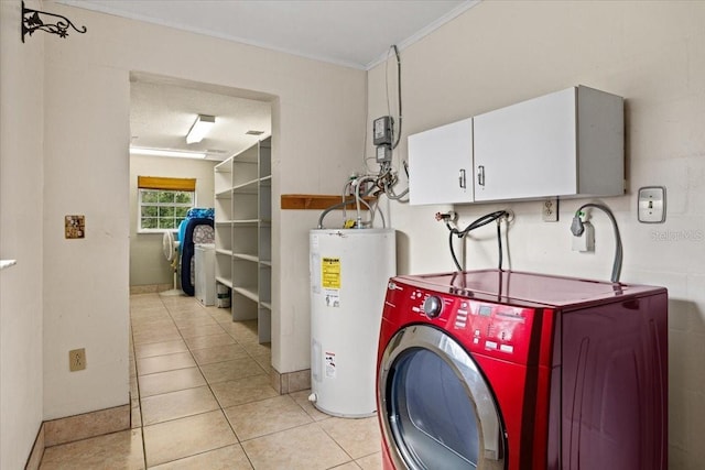 washroom with cabinets, ornamental molding, electric water heater, light tile patterned floors, and washer / dryer