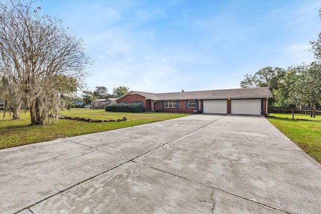 ranch-style house with a garage and a front lawn