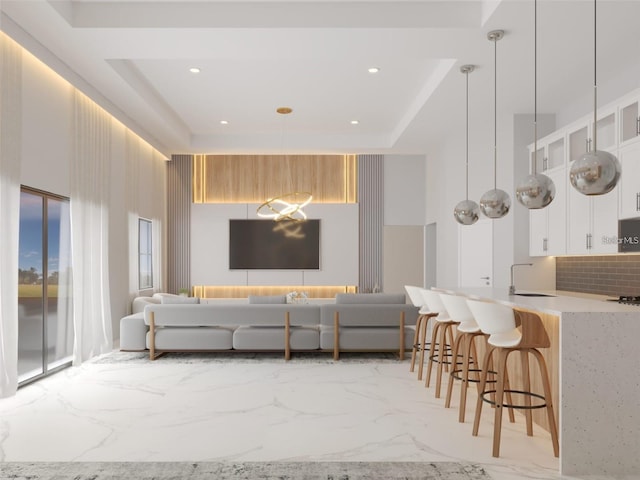 living room featuring sink and a high ceiling