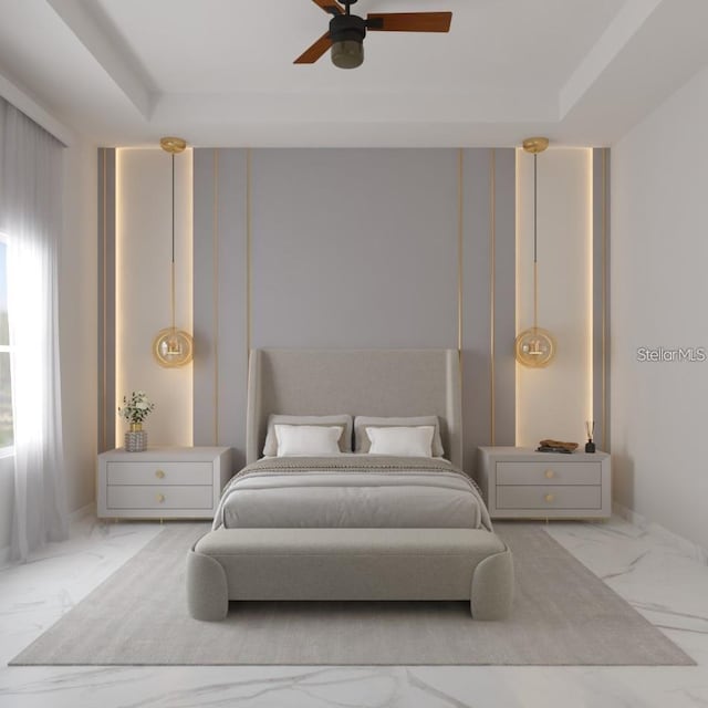 bedroom with a raised ceiling and ceiling fan