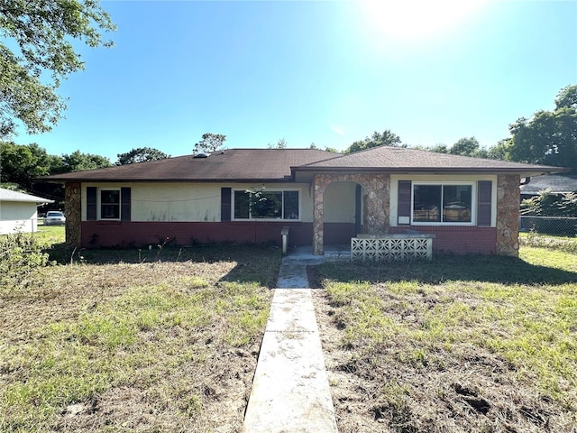 ranch-style home with a front lawn