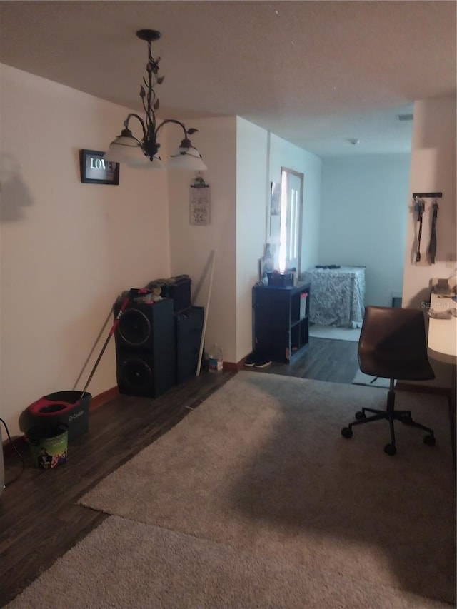 office area featuring dark hardwood / wood-style flooring and a chandelier