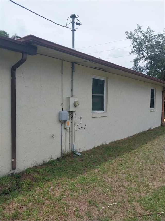 view of side of property with a yard