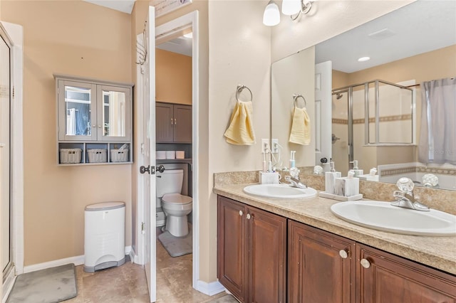 bathroom featuring vanity, toilet, and a shower with door