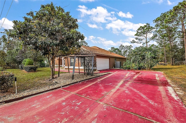 exterior space featuring a lawn and a garage